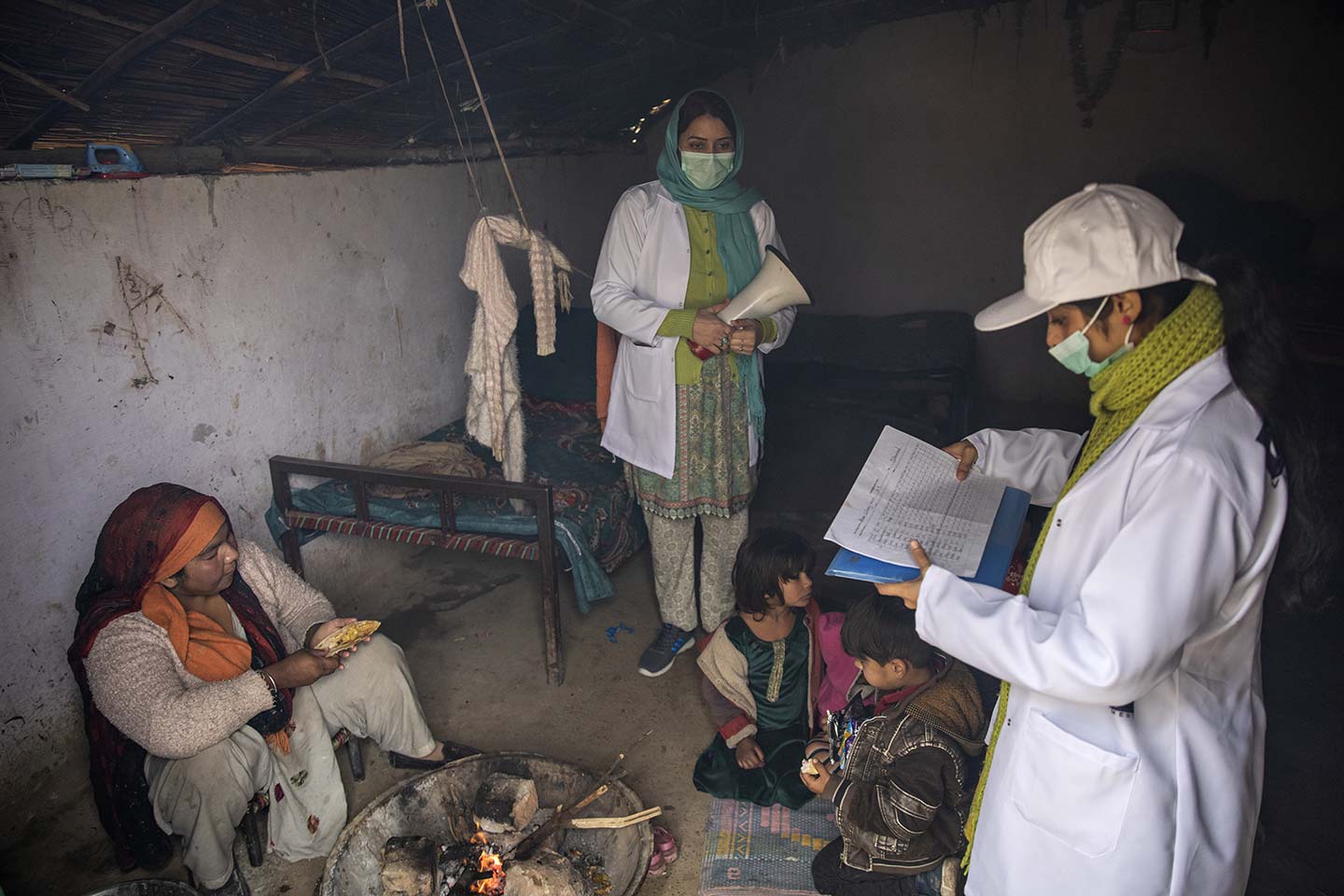 Sadaf Fareed, with her team checking the vaccination record of a child during their field work in a slum in Islamabad.  Credit: Gavi/2020/Asad Zaidi 