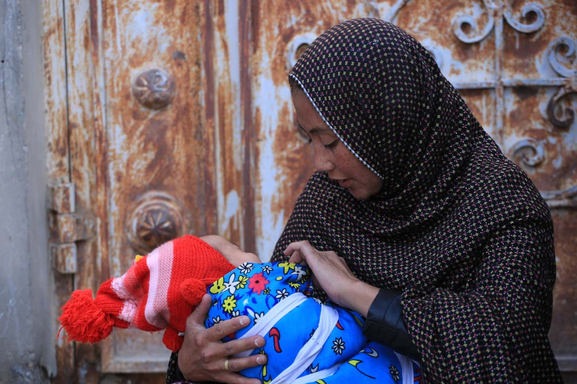 Yasameen, two months old, and her mother Sitara. Yasmeen lost her father recently and her mother does domestic work to support the family. ©Ramin Afshar/WHO Afghanistan