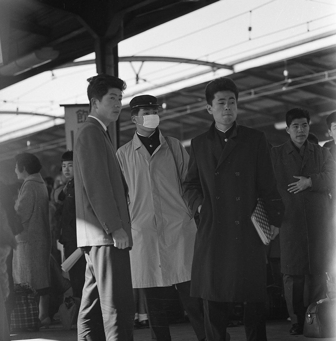 A student in Tokyo in the 1960s is wearing a mask to avoid infections  Credit: WHO/Paul Almasy