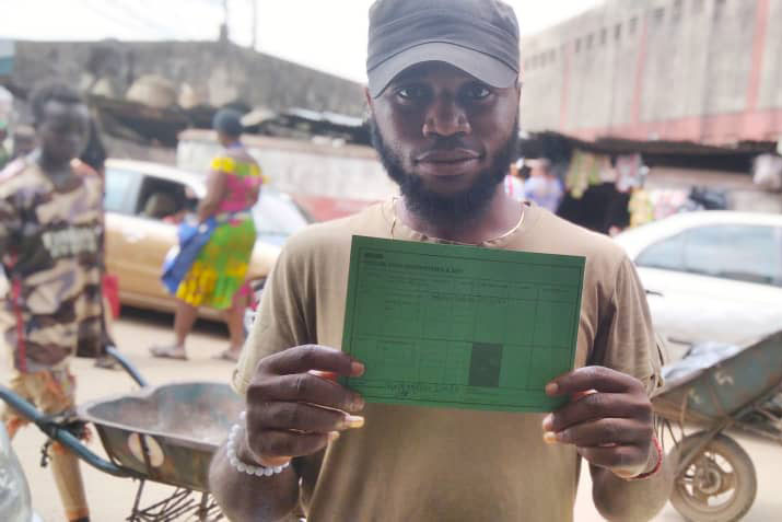 Williams Christian showcasing his COVID-19 Vaccination Card. Photo credit: Ijeoma Ukazu