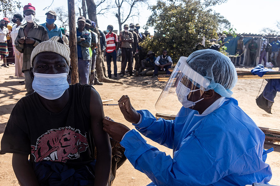 Isaac Tshuma, 37, a waste picker receives his first dose of COVID-19 vaccine at Ngozi Mine, Bulawayo.
