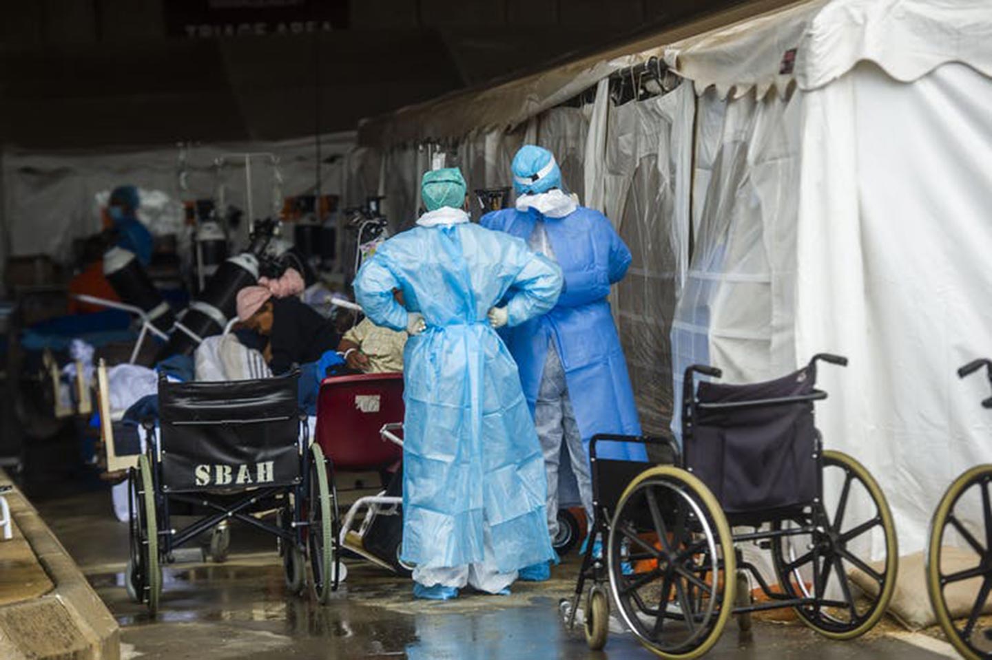 Health care workers and patients in the temporary outside area Steve Biko Academic Hospital created to screen and treat suspected Covid-19 cases in Pretoria. Alet Pretorius/Gallo Images via Getty Images