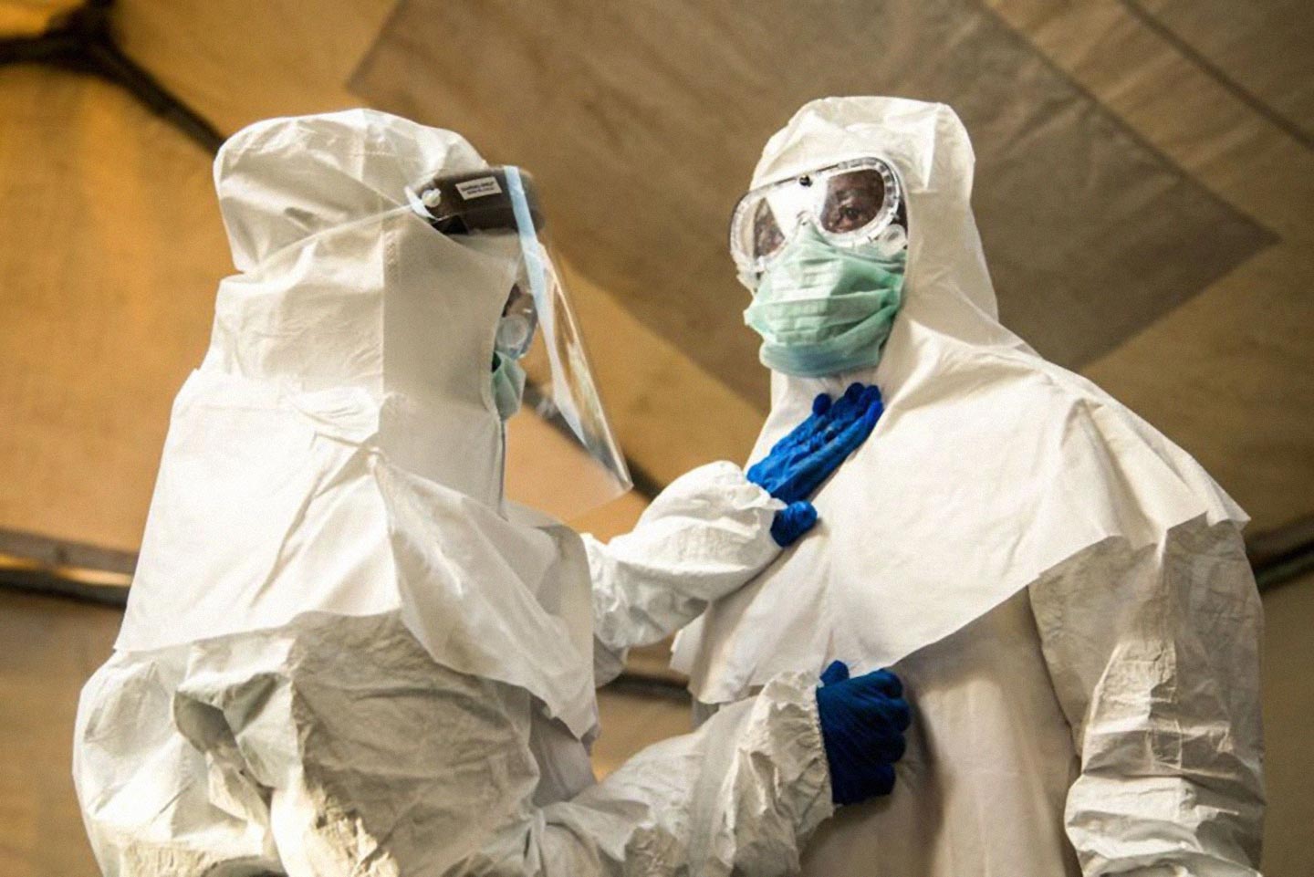 Medical staff check each others protective suits. Photo by SUMY SADURNI/AFP via Getty Images