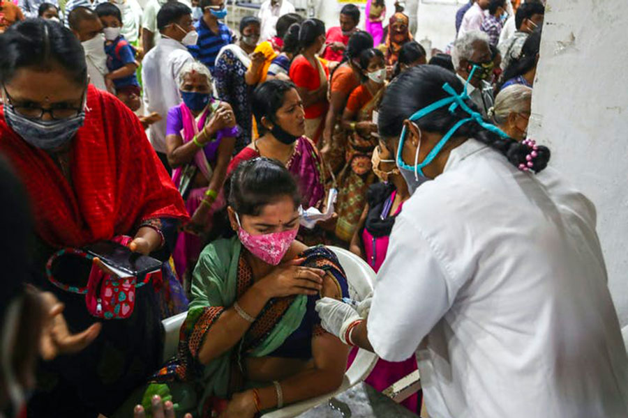 Lining up for a vaccine at a municipal stadium in Hyderabad, India. AP Photo/Mahesh Kumar A