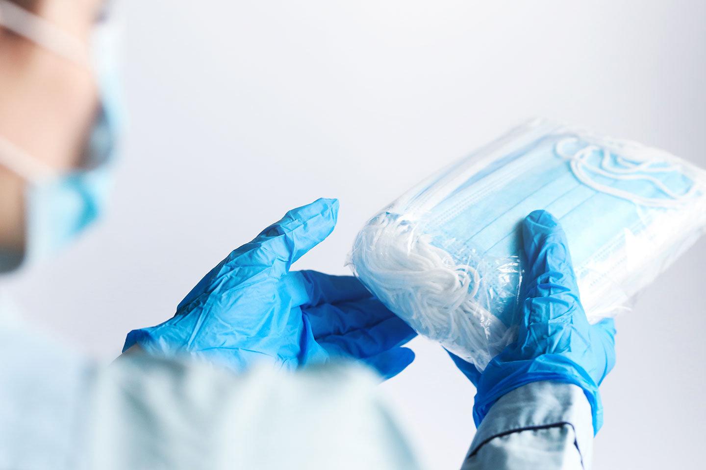 A person holds disposable face masks.