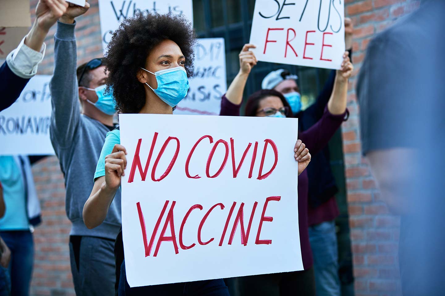 Crowd of people protesting against coronavirus vaccination.