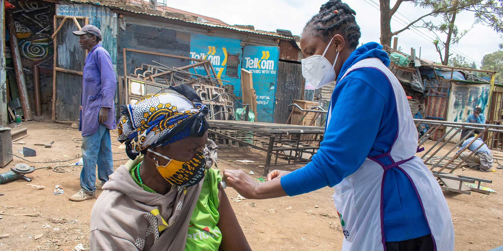 A SHOFCO health worker administering COVID-19 vaccines in Kibra slum during a mass vaccination exercise. Photo courtesy of SHOFCO