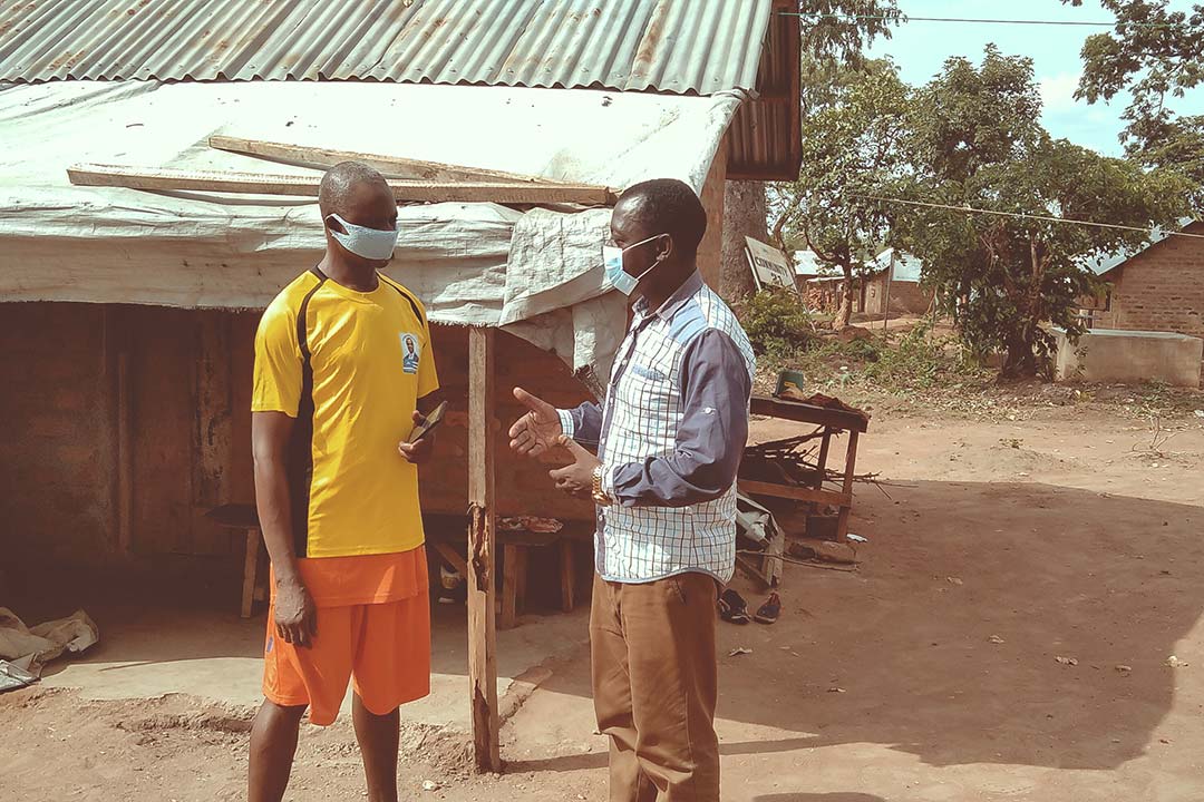 Laban educating Abor Peter on the need to protect himself against COVID-19 at Adagom 1 refugee settlement camp Ogoja. Photo Credit: Ijeoma Ukazu