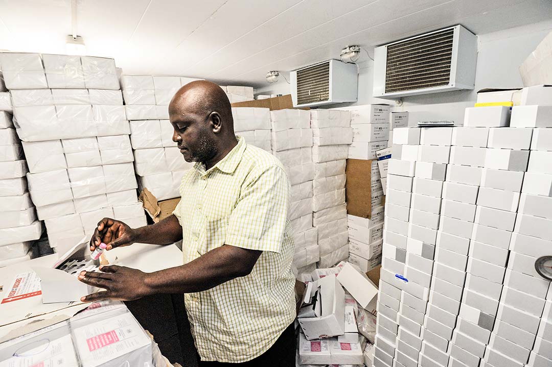 A cold room administrator checks vaccine stocks in Nigeria. Credit: GAVI/2013/Adrian Brooks