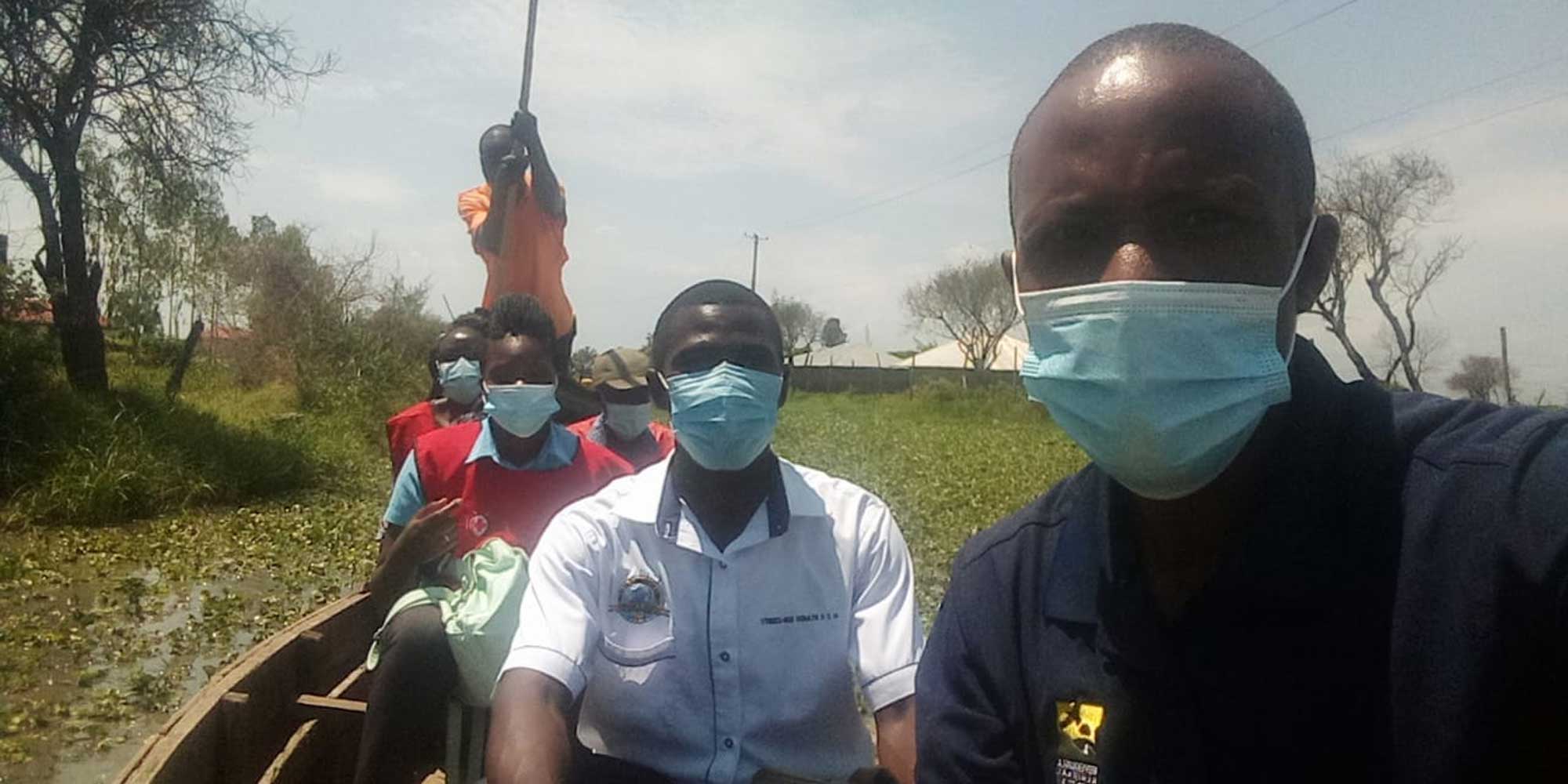 Wycliffe Welangai (in white) and colleagues punting towards a health outreach session during 2019's catastrophic floods.