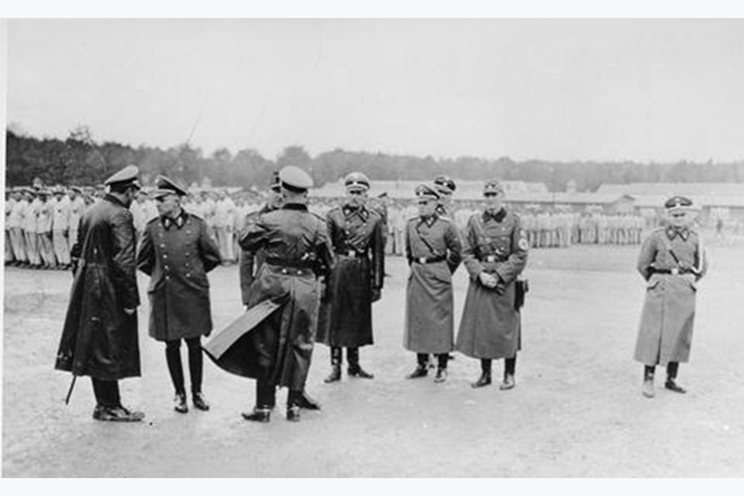 SS and police officials speaking among themselves during a roll call of Polish prisoners. Credit: United States Holocaust Memorial Museum