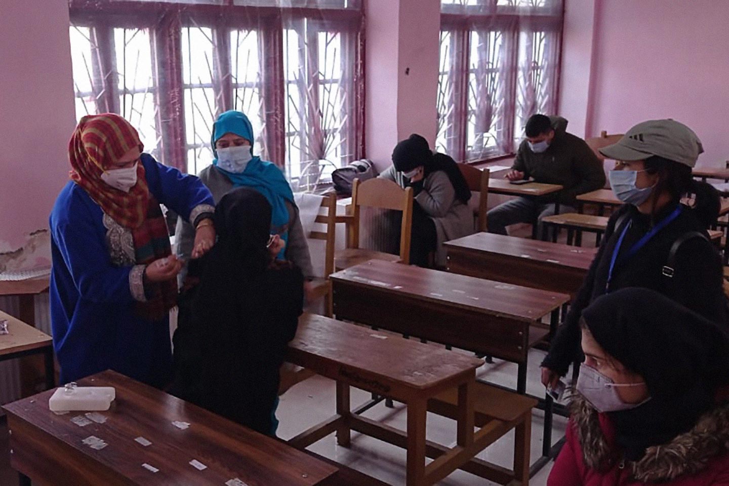 Students receiving their first dose of COVID-19 vaccine in Kothibagh Higher Secondary School, Srinagar