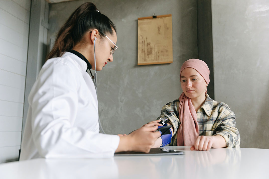 Female doctor checking cancer patient's blood pressure. Photo by Thirdman from Pexels