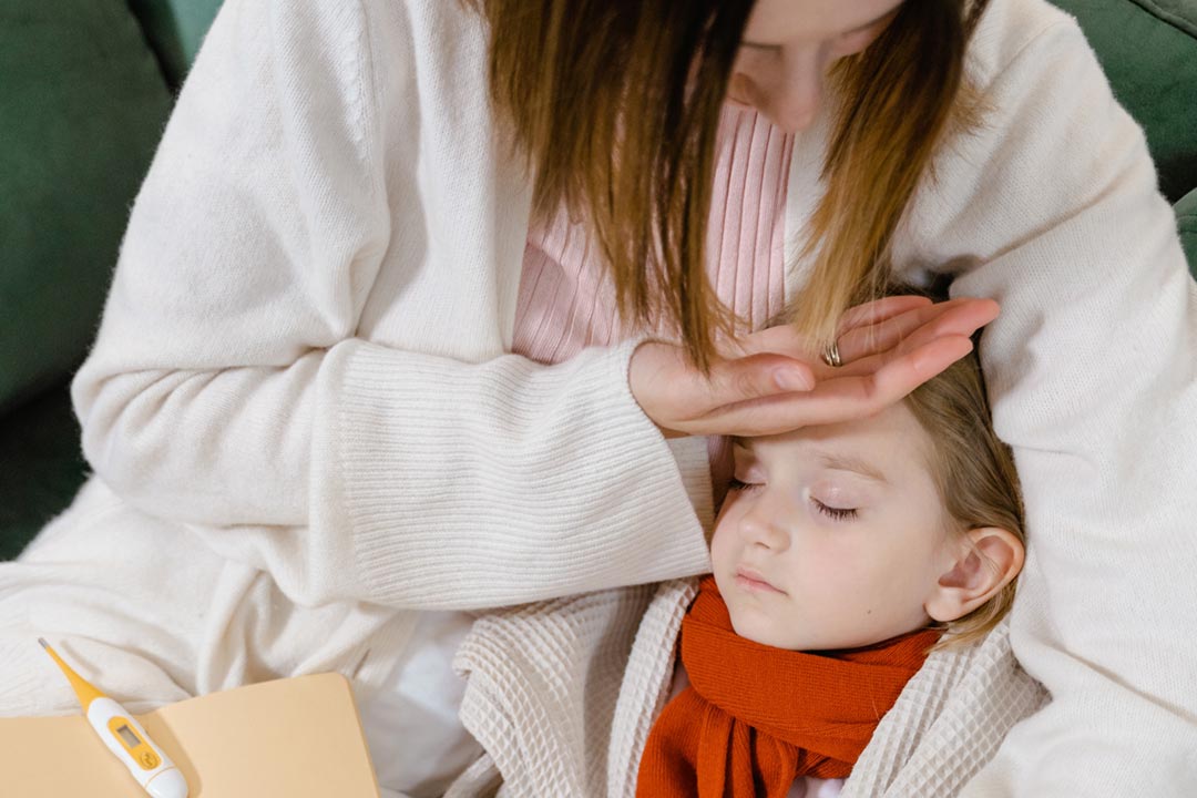 Woman checking her child's temperature. Credit: Tima Miroshnichenko/Pexels