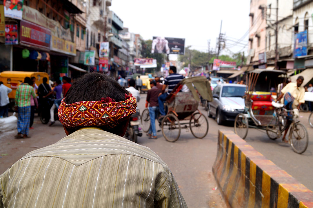 A rikshaw driver on the streets of Varanasi during a hot afternoon.