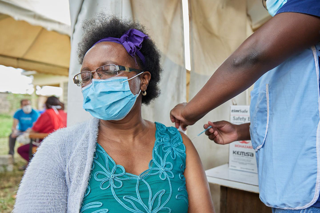 Woman receiving COVID-19 vaccine. Photo credit: UNICEF