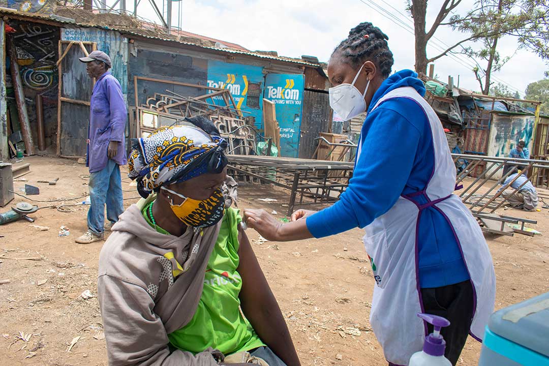 A SHOFCO health worker administering COVID-19 vaccines in Kibra slum during a mass vaccination exercise. Photo courtesy of SHOFCO