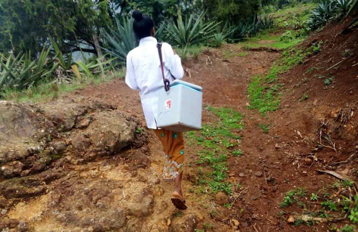 A health worker from Kanko traveling to remote villages to reach children missing out on routine immunisation.