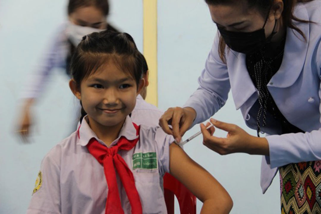 A girl receives her first dose of HPV vaccine in Laos