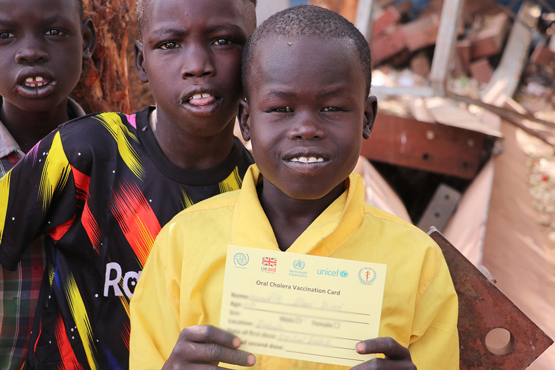 A child shares his vaccination card after receiving the cholera vaccine. Photo credit: WHO