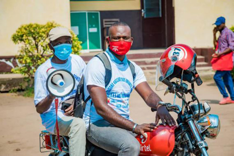 Volunteer dispatcher, Guy Mbika, fetches and carries health workers on his motorbike, and takes them around Brazzaville to deliver and administer COVID-19 vaccines. Credit: Victor Muisyo
