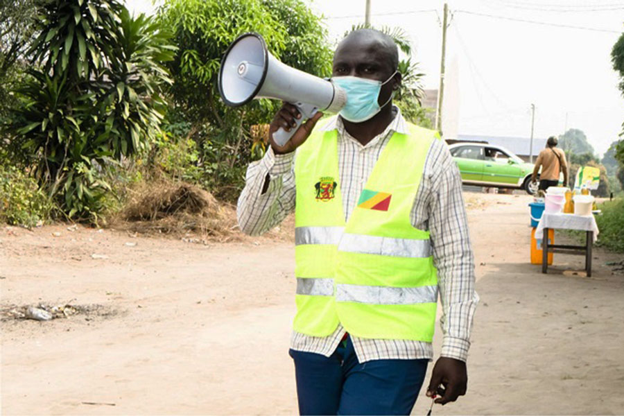 Darel, a town crier hired by the Mayanga Integrated Health Centre, at work.