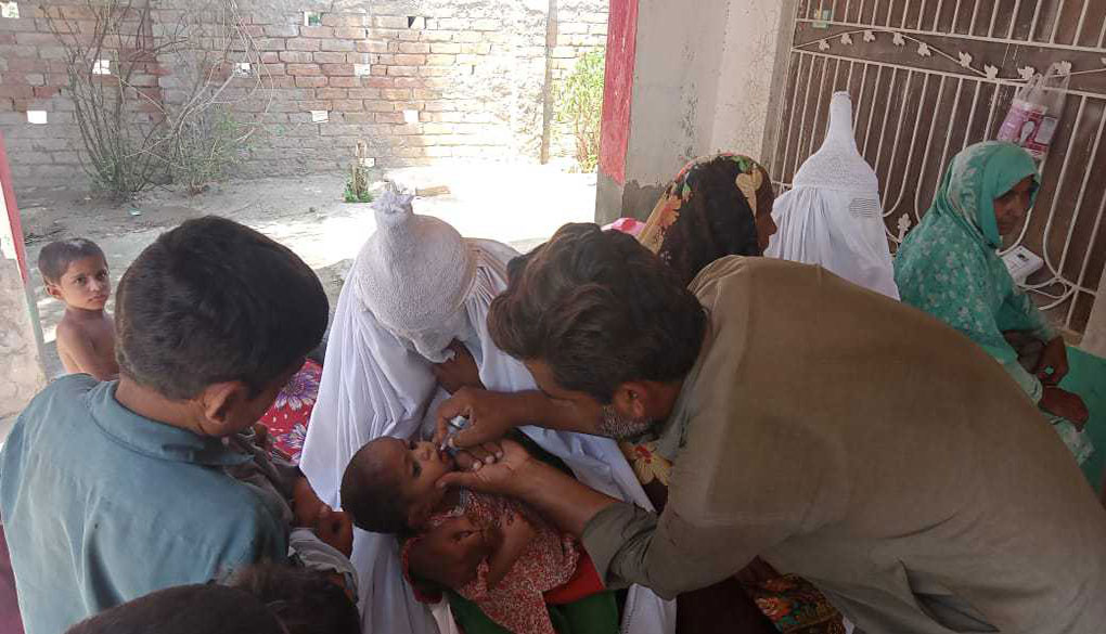 Sakeena Bibi getting polio vaccine to her daughter