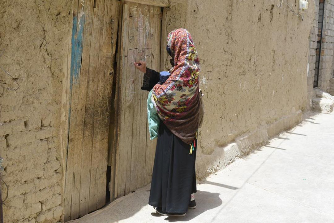 Health workers go door to door to ensure no child misses out on polio vaccines. Credit: Ministry of National Health Services