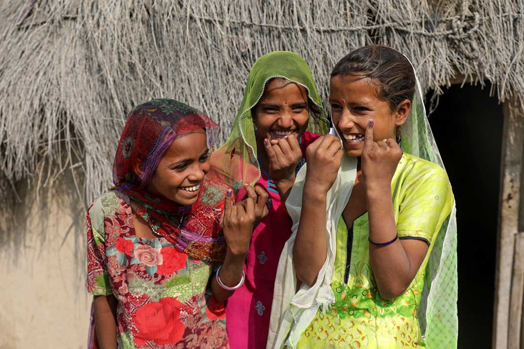 Girls in Pakistan proudly show the ink mark on the tip of their finger. It proves that she has been vaccinated against measles and rubella. Credit: Gavi/2021/Asad Zaidi 