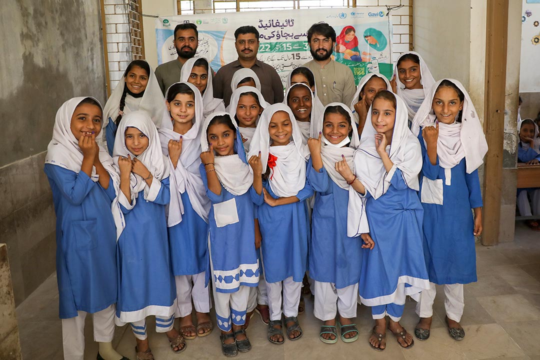 Pupils from the government girls’ middle school of Bagan Baba in Dera Allah Yar show off marks on their fingers signifying that they have received a dose of TCV. Credit: Gavi/Asad Zaidi