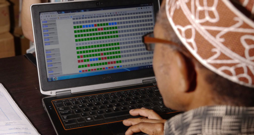 A Regional Immunization and Vaccine Officer monitoring the performance of cold chain equipment in Tanzania using the Nexleaf data dashboard. Credit: Ian Connors