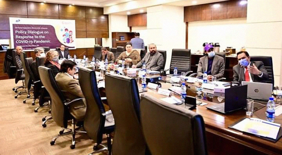 Zubair Faisal Abbasi (right) addresses a meeting on policy dialogue in response to COVID19. Photo credit: Saadeqa Khan