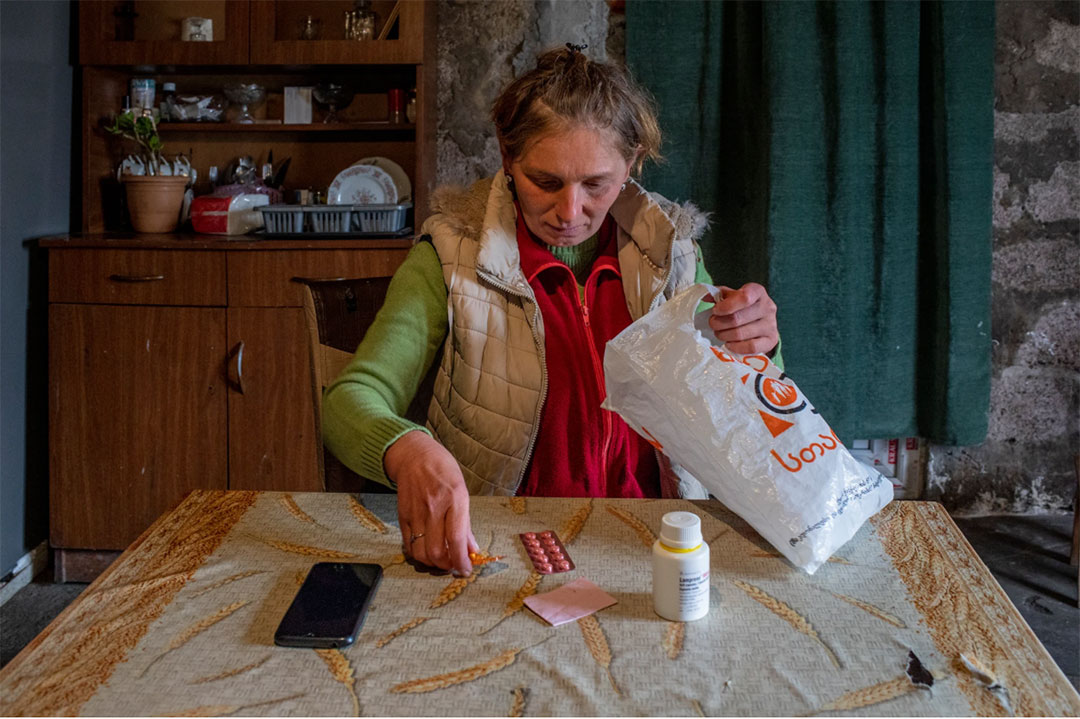 Maia prepares to take her daily TB medication. Maia records herself taking her daily medication and then uploads the recording onto the AdhereTB mobile application. A nurse then reviews it.