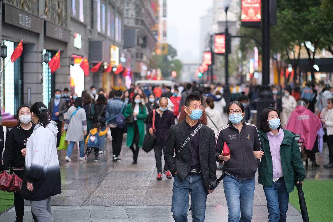 people in face mask to prevent coronavirus, walking on Jianghan Road. Jianghan Road is a famous commercial street in Wuhan