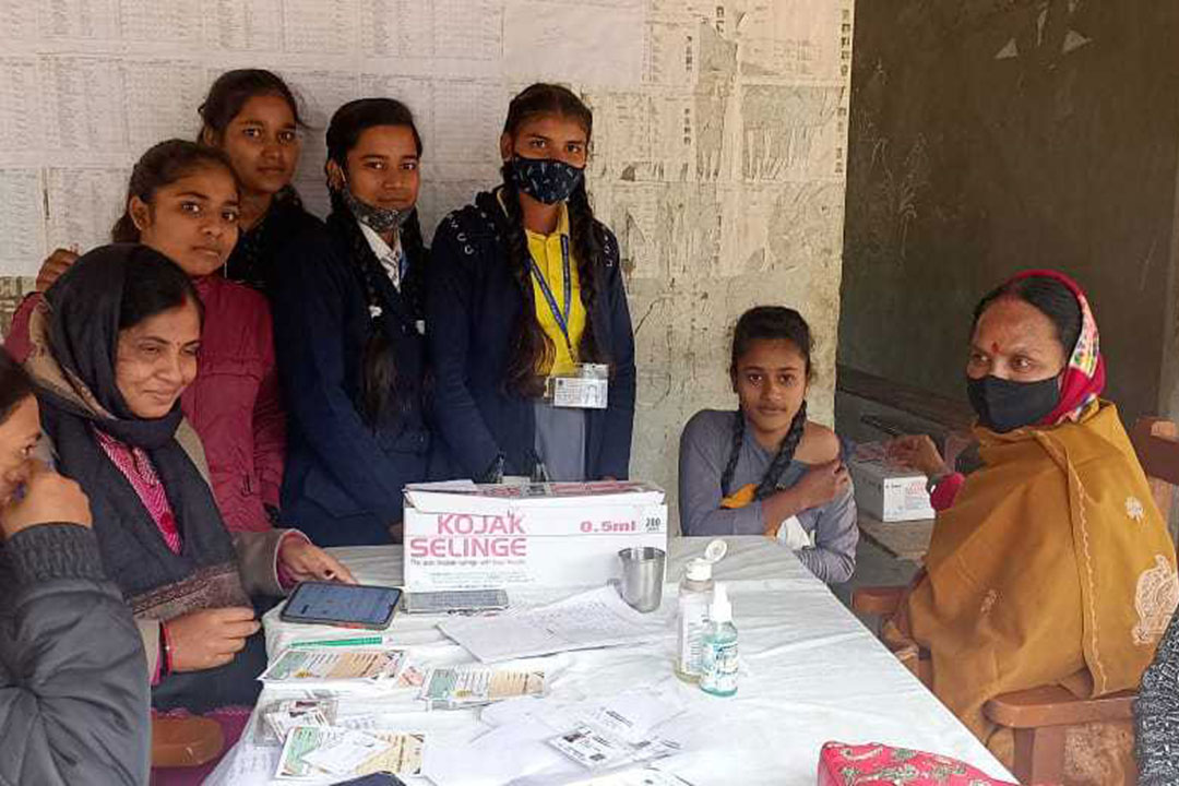 Children wait for their turn to receive the COVID-19 vaccine at A.N. Singh Senior Secondary School. Credit: Abhay Rao