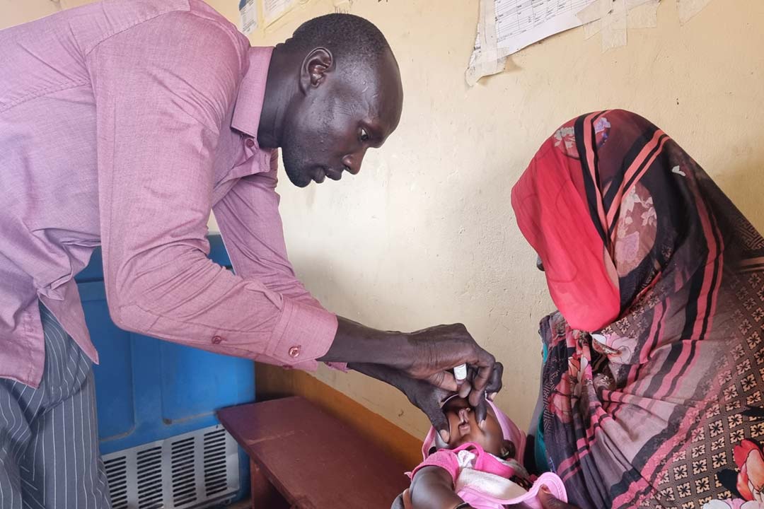 Ahoc-Thon giving oral vaccine to a baby. Credit: Winnie Cirino