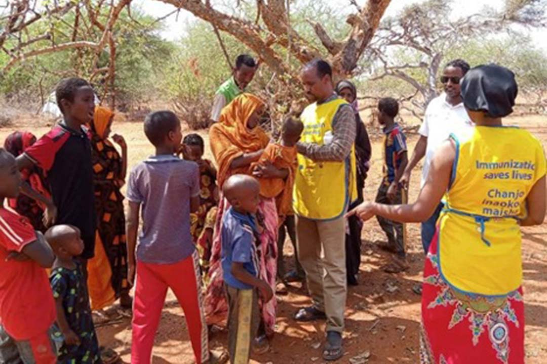 Clinicians Sudani Abdi Awad and Sahra Ali giving the MMR vaccine shot to a child in Derkhale Ward, Banissa Constituency. Credit: Mohamed Ali, Mandera County press.