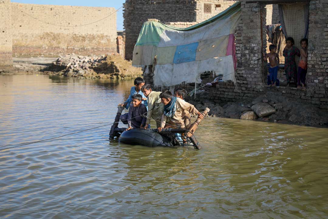 Young boys crossing flood water on a locally made boat in Sohbatpur city, full of flood water in Sohbatpur District, Baluchistan Province, Pakistan. Credit: Gavi/2022/Asad Zaidi