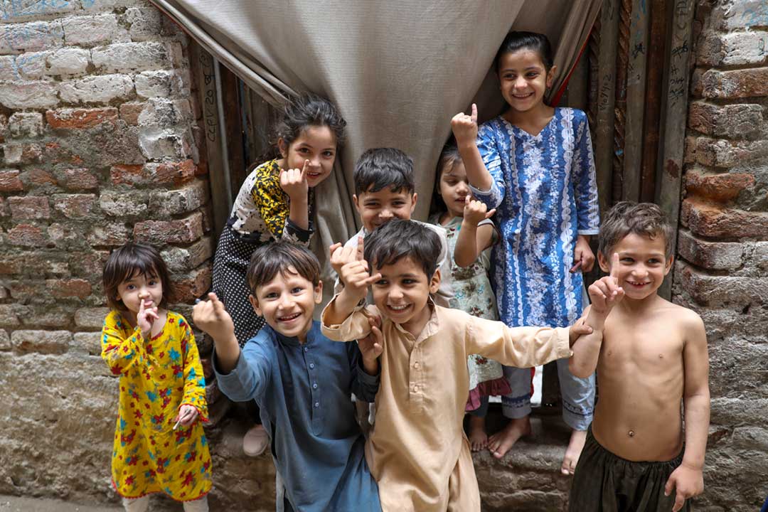 Young boys and girls proudly showing finger marking after getting vaccination against Polio, during the door-to-door polio campaign during the Ramzan in Rasheed Garhi, Peshawar city, Pakistan. Credit: Gavi/2023/Asad Zaidi