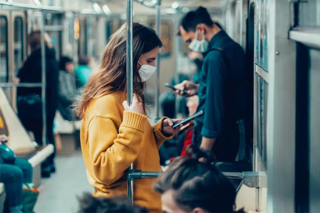 People on a train wearing masks. Credit: SmartPhotoLab/Shutterstock