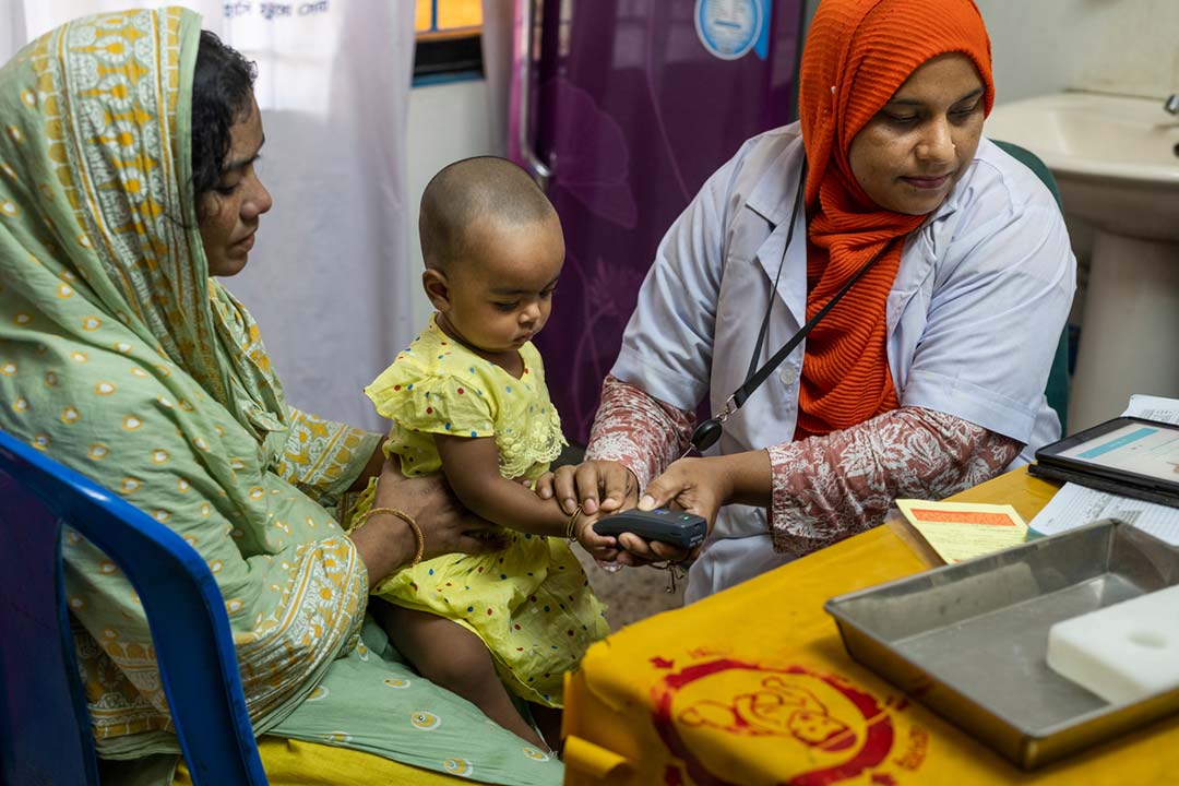 A vaccinator takes a child’s fingerprint ahead of vaccination. Credit: Ashraful Arefin