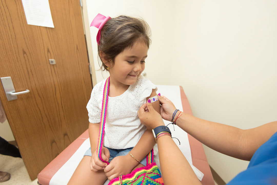 Little girl getting a bandaid. Credit: CDC on Unsplash