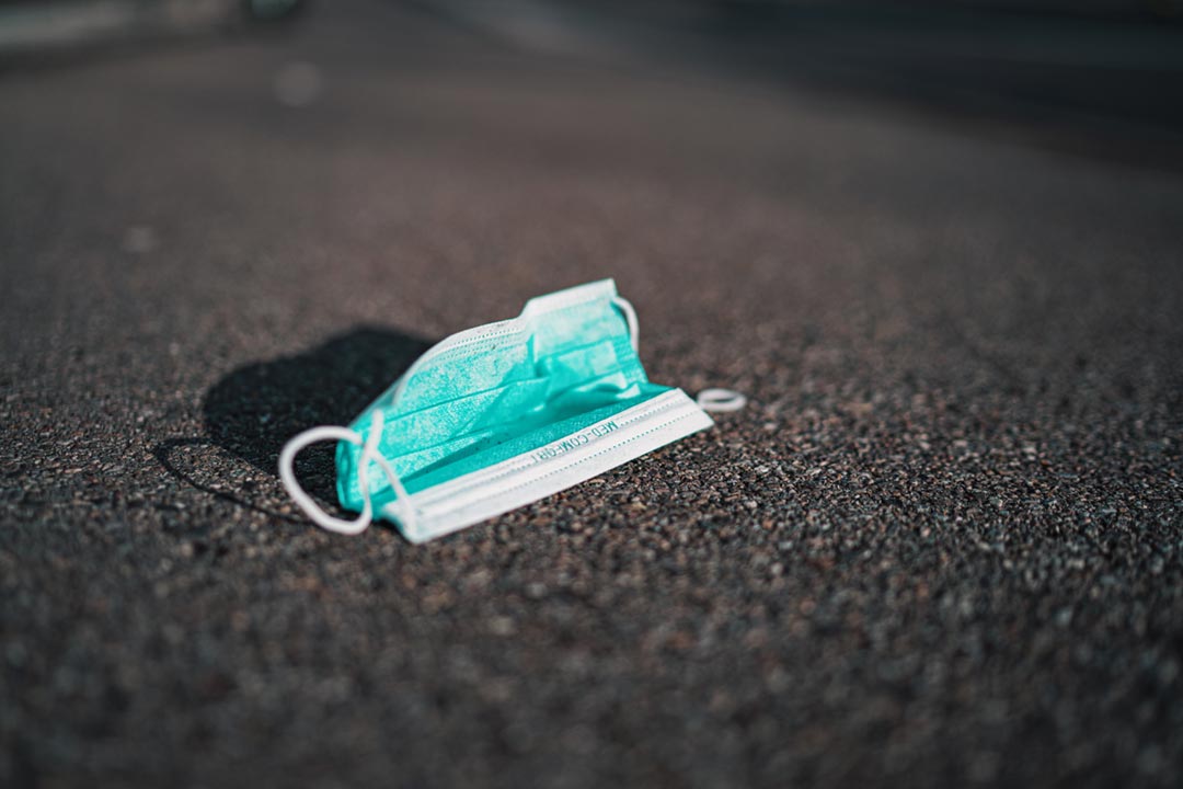 A medical face mask on the ground. Credit: Claudio Schwarz on Unsplash