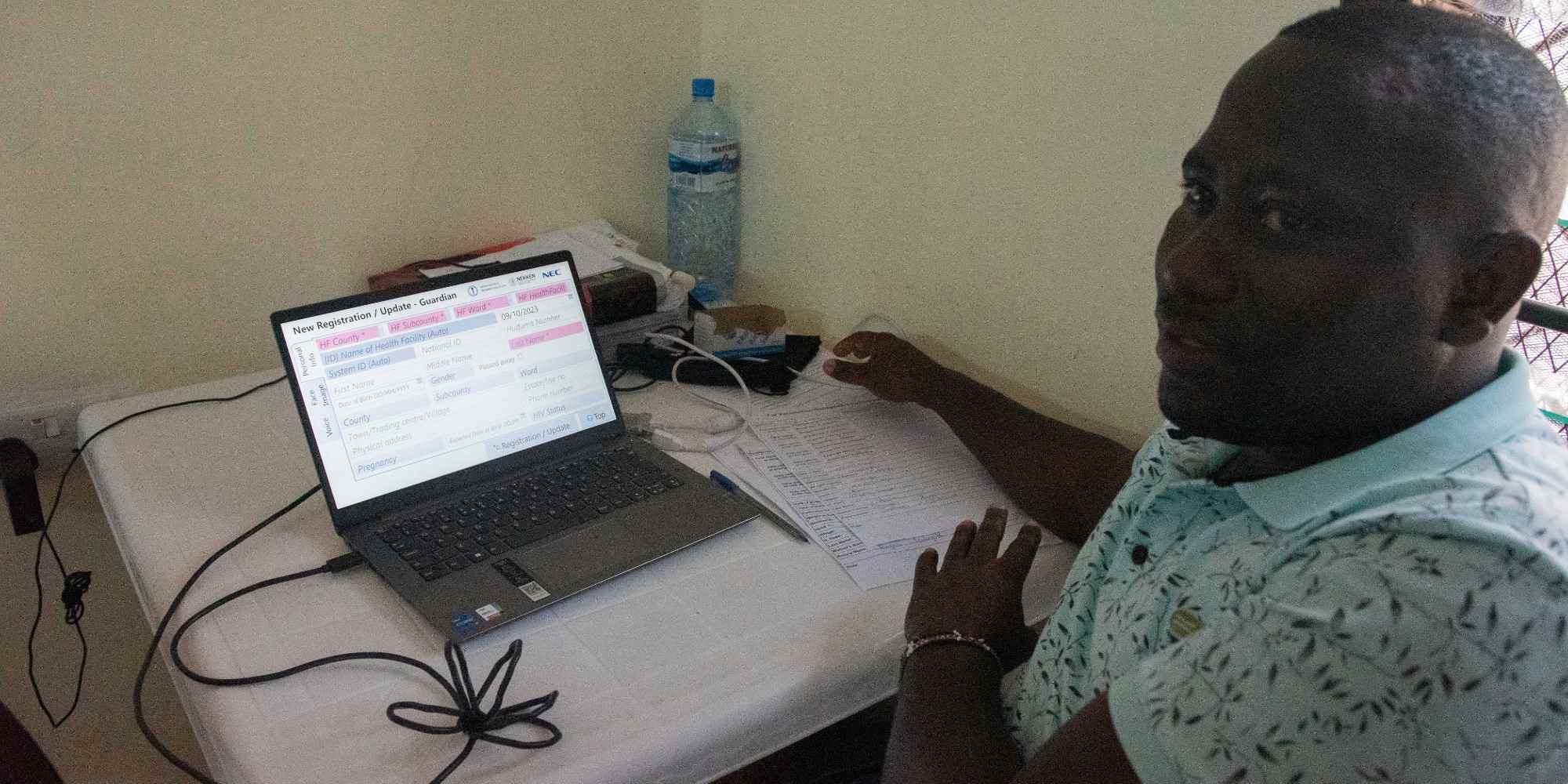 Ismail Mugandi Zani, l'officier du KEMRI, enregistre les informations civiles de la mère de Joshua. Crédit: Claudia Lacave / Hans Lucas
