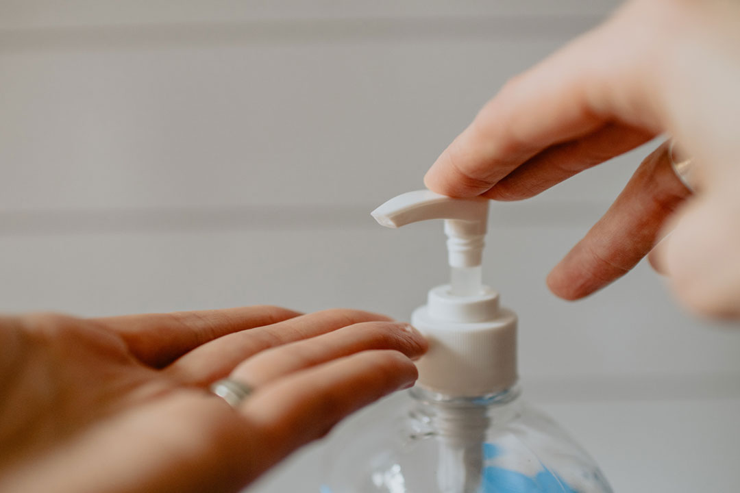 Hands pumping hand sanitizer. Credit: Kelly Sikkema on Unsplash