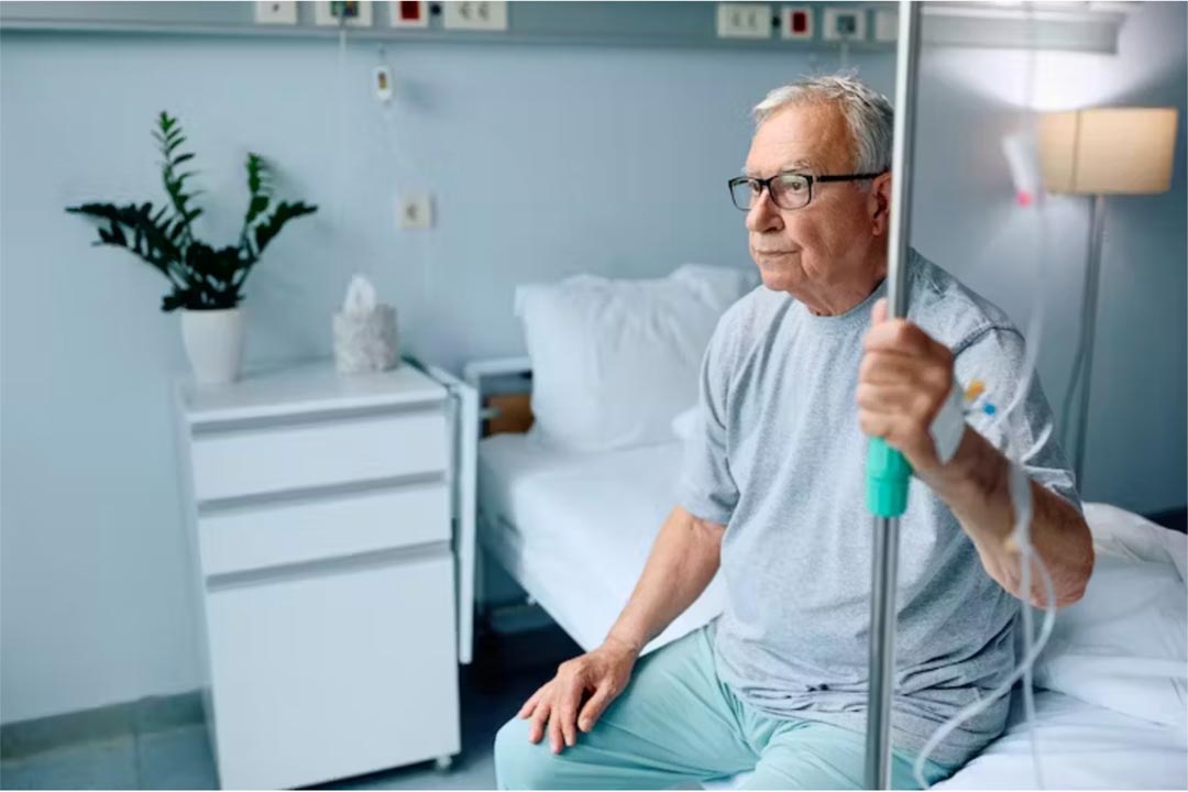 Old man sitting on a hospital bed. Credit: Drazen Zigic/Shutterstock