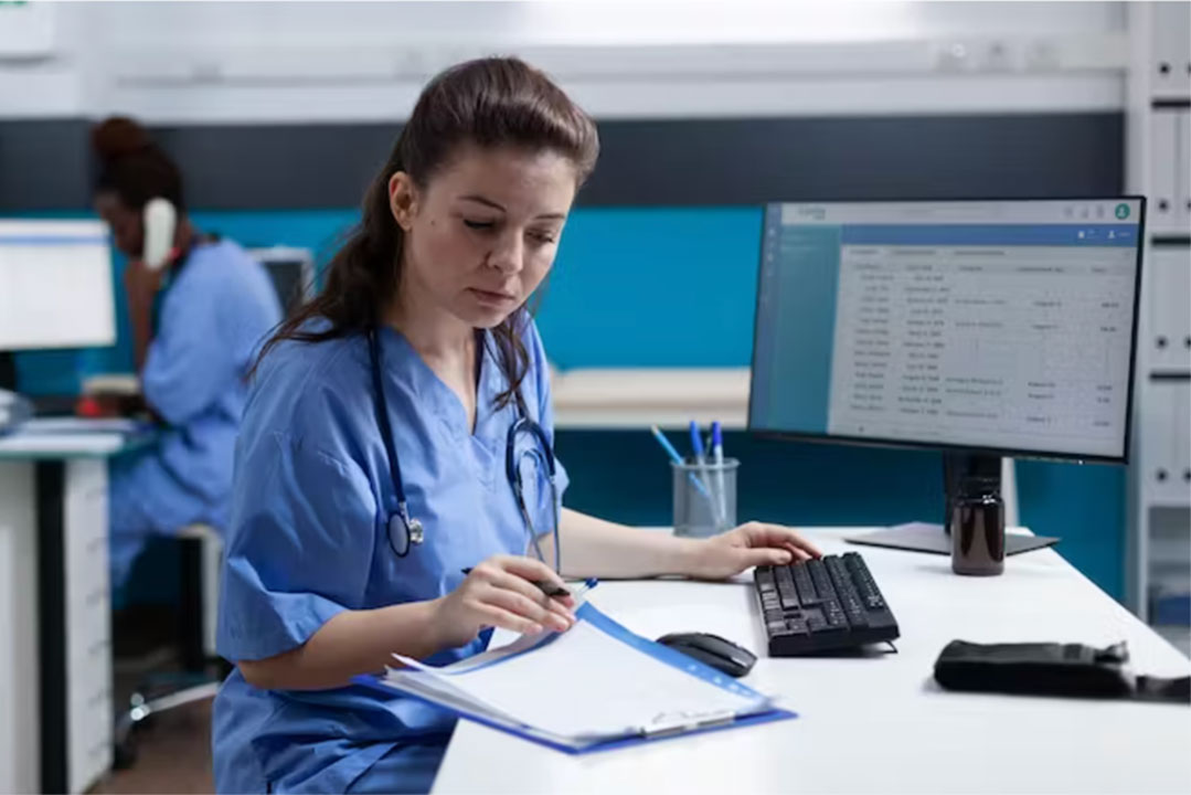 Medical worker in front of a computer. Credit: Shutterstock