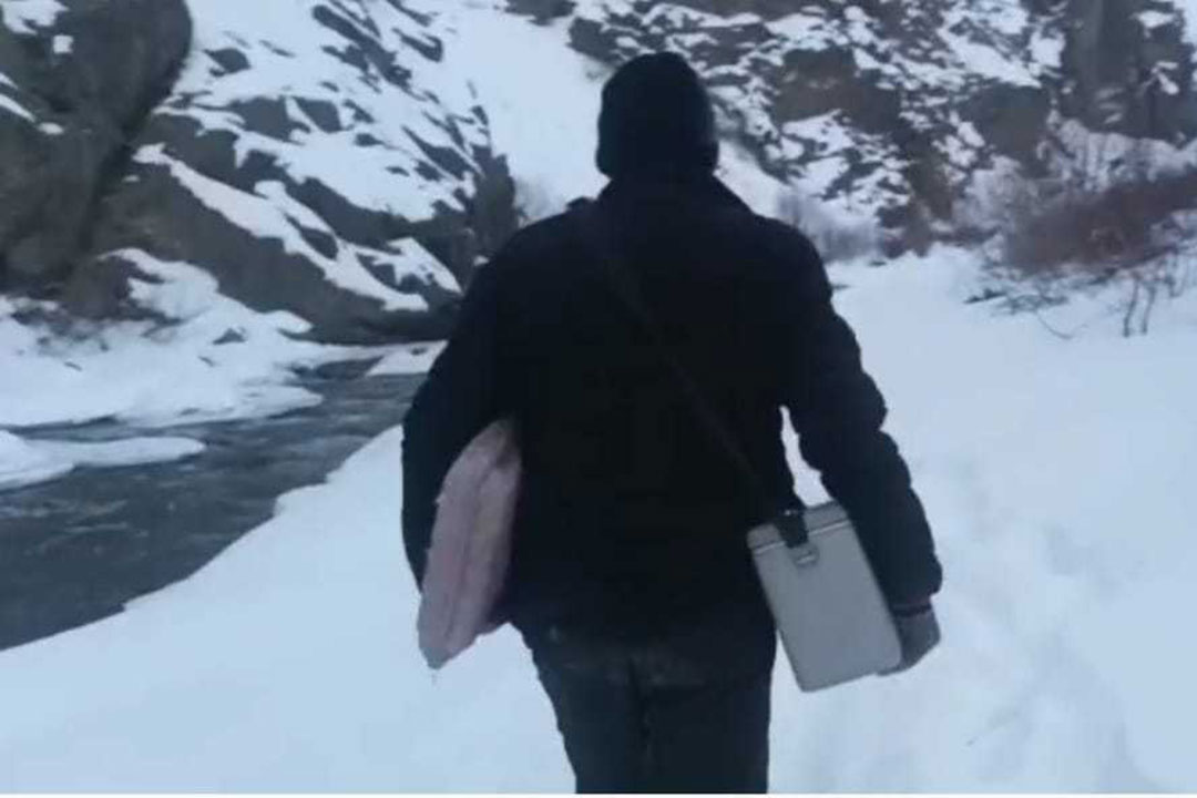 Health worker SulemanSuleman, with vaccines and other medical aid, on the path to Itchoo amidst snow and ice. Credit: Block Medical Office, Sankoo.