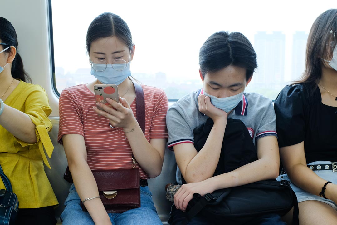 People on public transport wearing face masks. Credit: Zhang Kenny on Unsplash