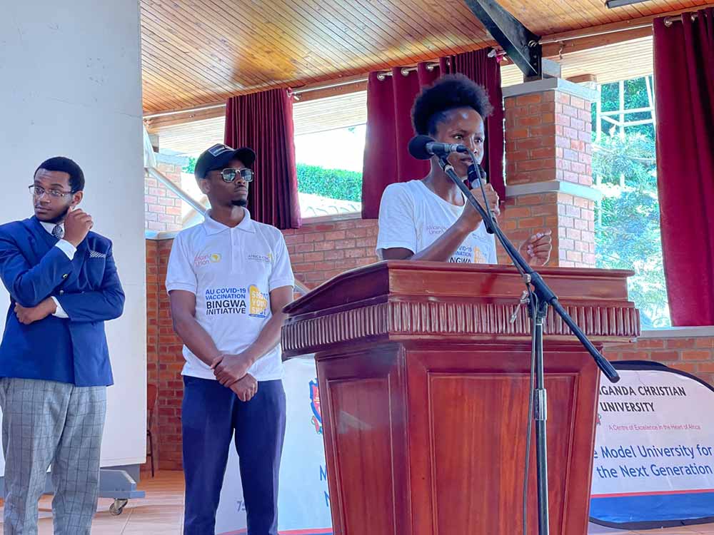 Doreen Naiga (right) and another African CDC Bingwa encouraging young people to take COVID-19 vaccines at a chapel at UCU. Credit: Doreen Naiga